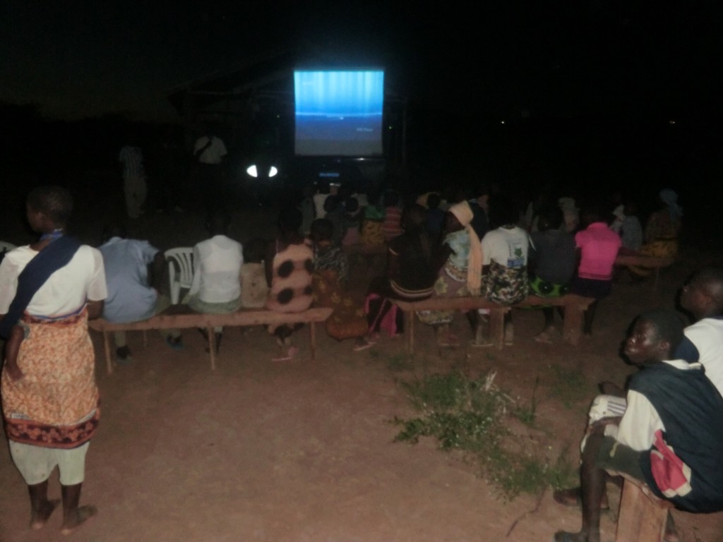 Community members watching the films at night