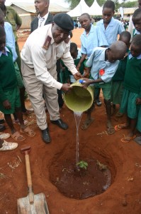 The chief with the school kids planting a tree around the school compound during the event.